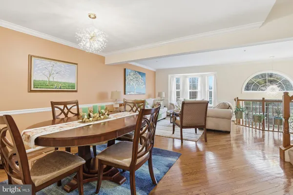a view of a dining room with furniture wooden floor and chandelier