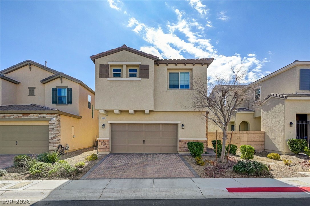 113 Elm Reed Avenue Las Vegas, NV 89113 - Photo 1 of 62 Mediterranean / spanish-style house featuring an attached garage, stucco siding, decorative driveway, and stone siding