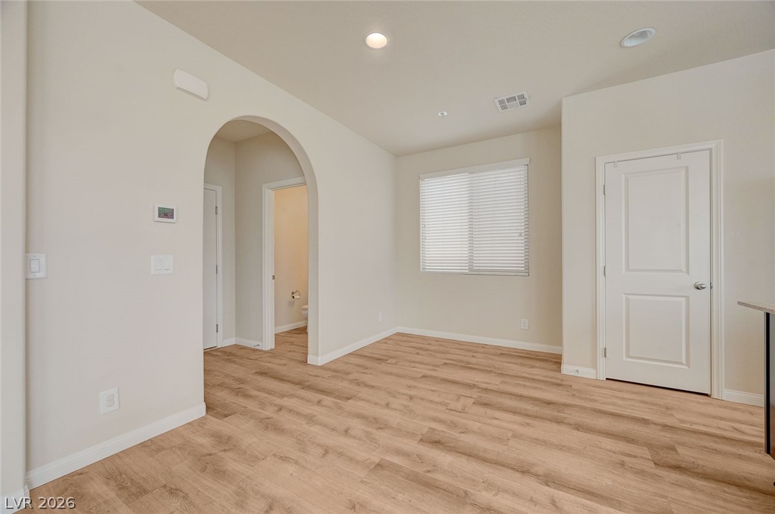 113 Elm Reed Avenue Las Vegas, NV 89113 - Photo 15 of 62 Spare room with arched walkways, light wood-style floors, and recessed lighting