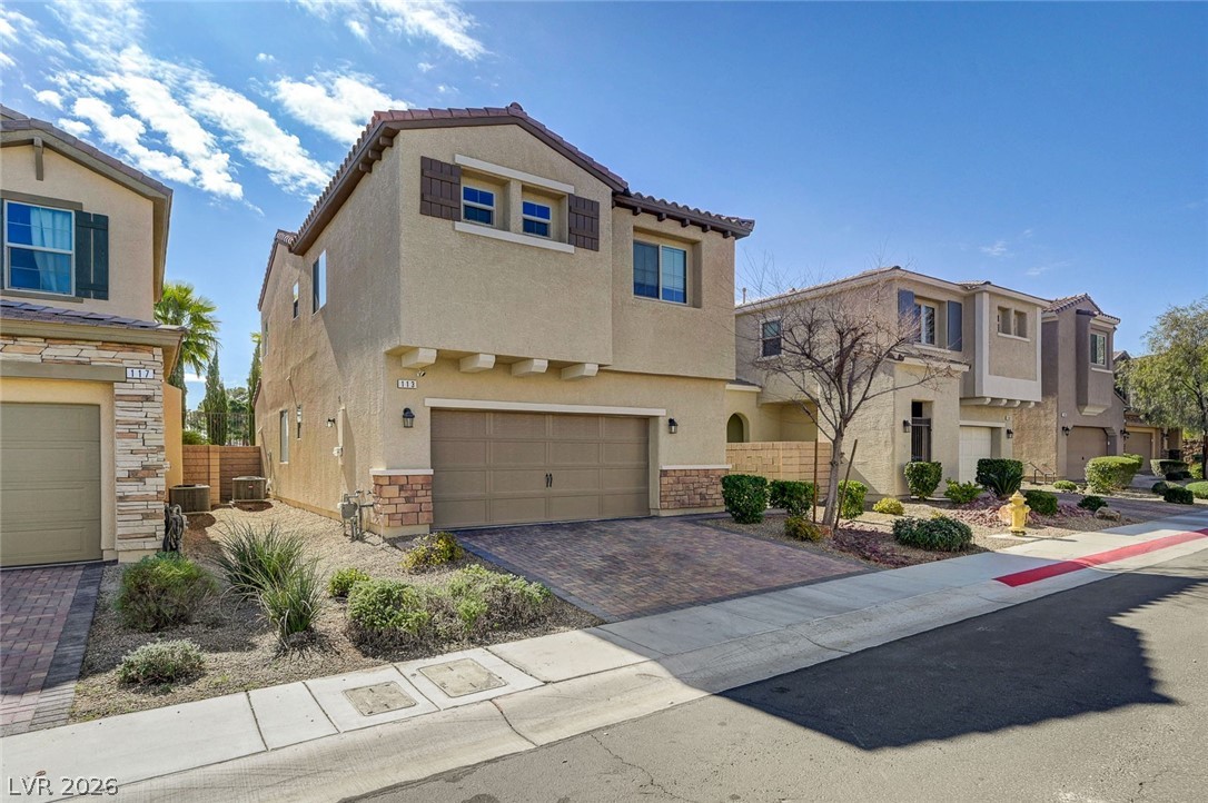 113 Elm Reed Avenue Las Vegas, NV 89113 - Photo 2 of 62 Mediterranean / spanish-style home featuring stucco siding, a garage, decorative driveway, and a tile roof