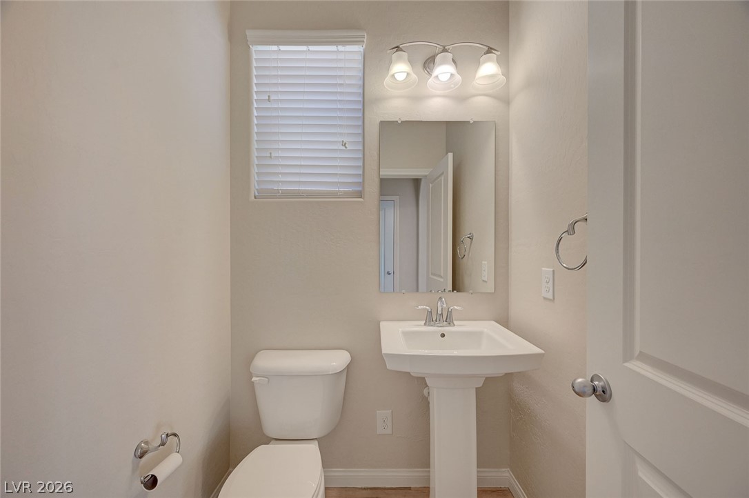 113 Elm Reed Avenue Las Vegas, NV 89113 - Photo 24 of 62 Half bath featuring toilet and baseboards