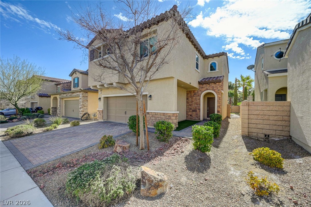 113 Elm Reed Avenue Las Vegas, NV 89113 - Photo 3 of 62 Mediterranean / spanish-style home with stone siding, stucco siding, driveway, and a garage