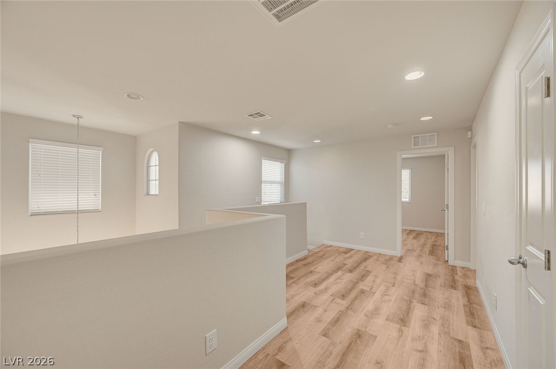 113 Elm Reed Avenue Las Vegas, NV 89113 - Photo 29 of 62 Hallway with recessed lighting and light wood-style floors