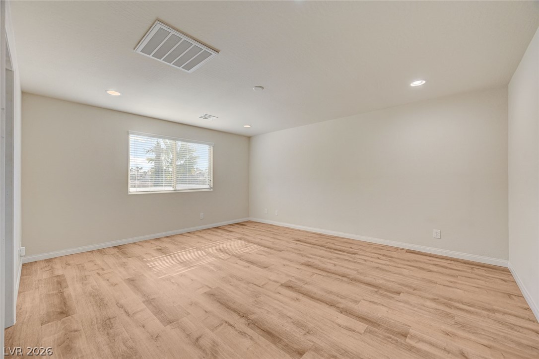 113 Elm Reed Avenue Las Vegas, NV 89113 - Photo 30 of 62 Spare room with light wood finished floors and recessed lighting