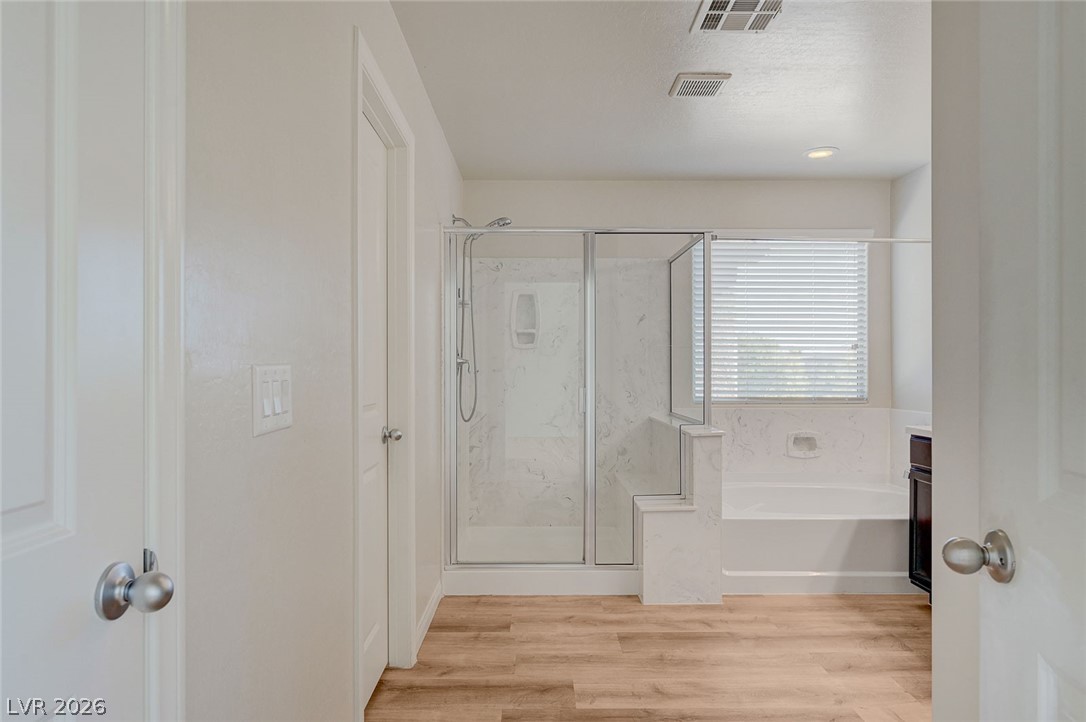 113 Elm Reed Avenue Las Vegas, NV 89113 - Photo 33 of 62 Bathroom with a marble finish shower, vanity, light wood-style flooring, and a bath