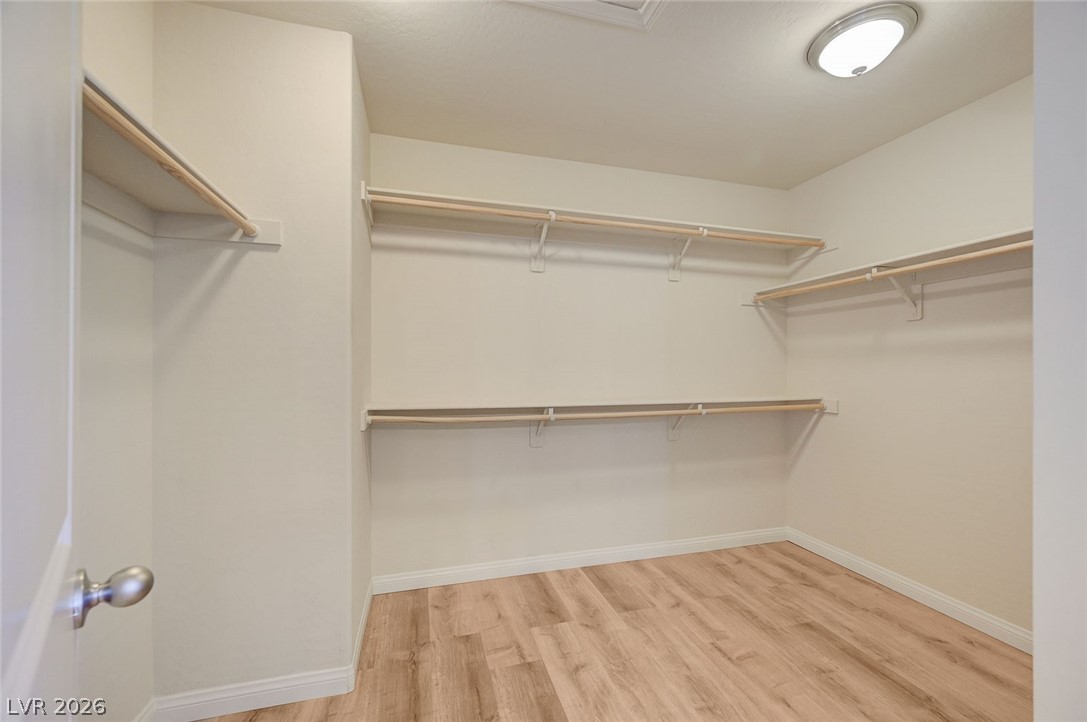 113 Elm Reed Avenue Las Vegas, NV 89113 - Photo 37 of 62 Walk in closet with light wood-style floors