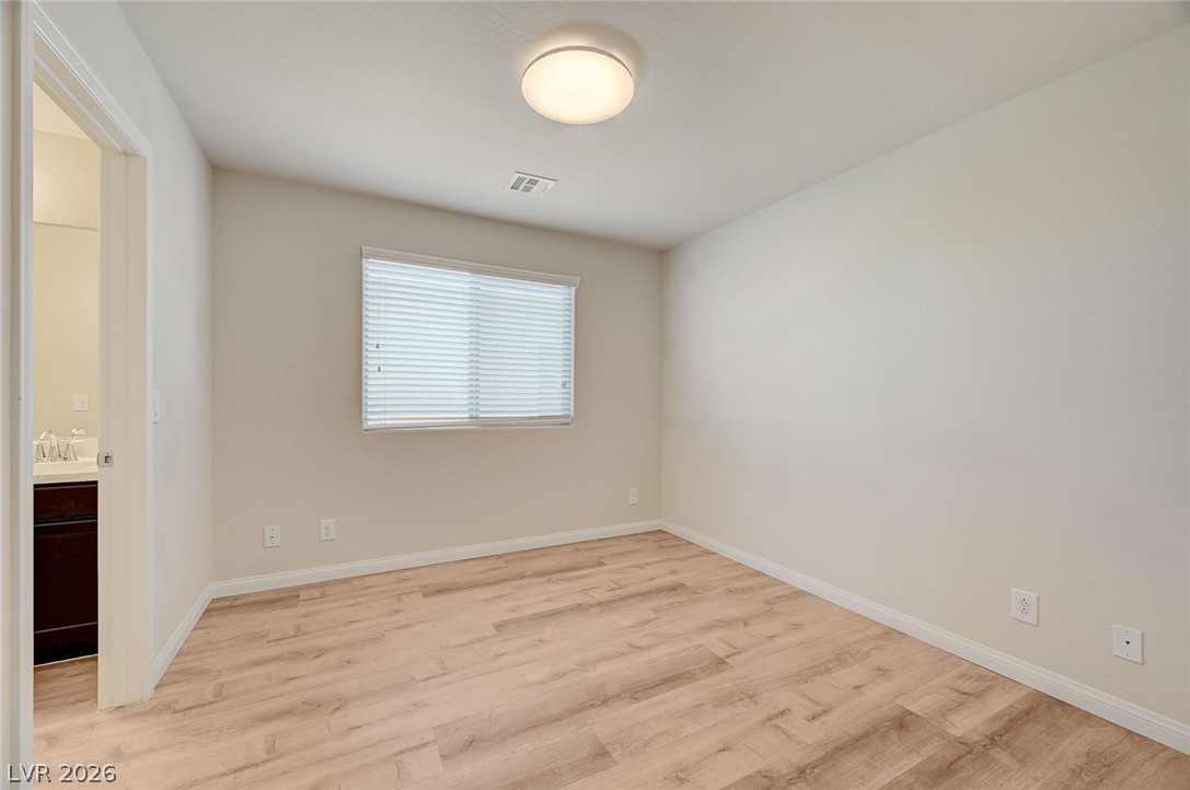 113 Elm Reed Avenue Las Vegas, NV 89113 - Photo 39 of 62 Unfurnished bedroom with light wood-style flooring and ensuite bath