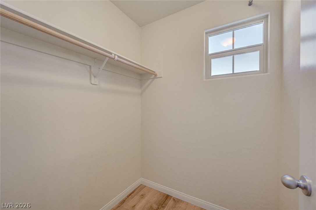 113 Elm Reed Avenue Las Vegas, NV 89113 - Photo 44 of 62 Walk in closet with light wood-style floors