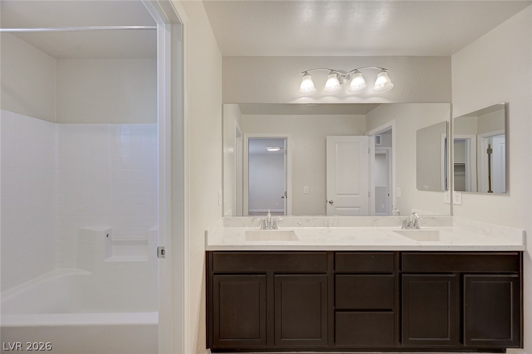 113 Elm Reed Avenue Las Vegas, NV 89113 - Photo 47 of 62 Bathroom with double vanity and shower / tub combination