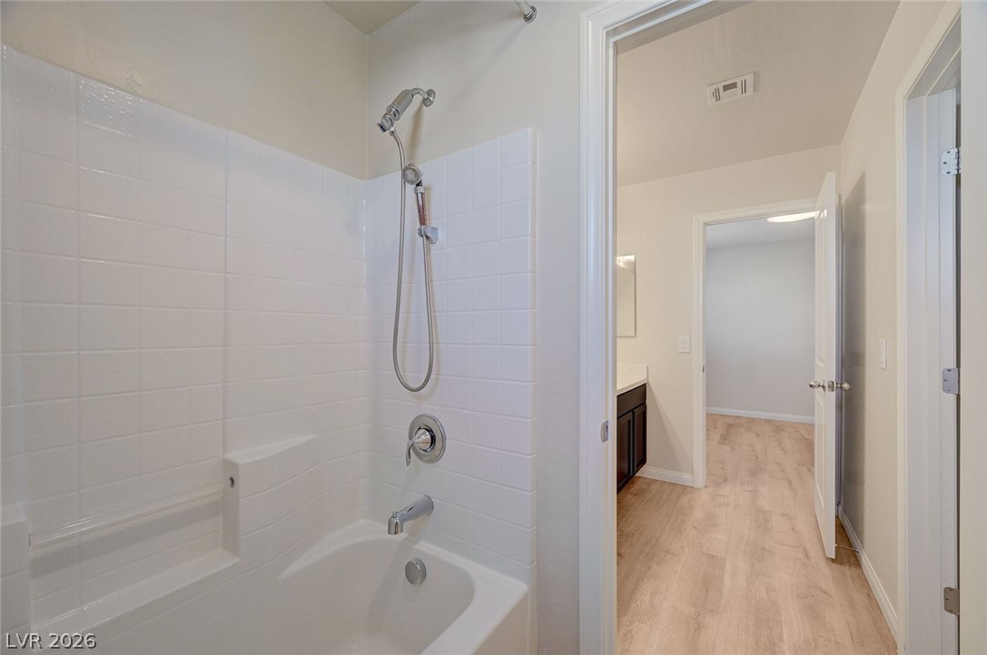 113 Elm Reed Avenue Las Vegas, NV 89113 - Photo 49 of 62 Bathroom with tub / shower combination, vanity, and light wood-type flooring