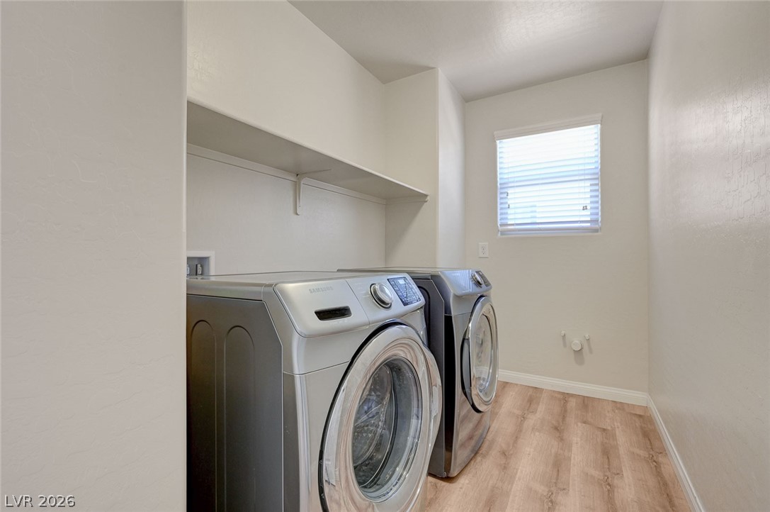 113 Elm Reed Avenue Las Vegas, NV 89113 - Photo 50 of 62 Laundry room with washer and dryer and light wood-style flooring