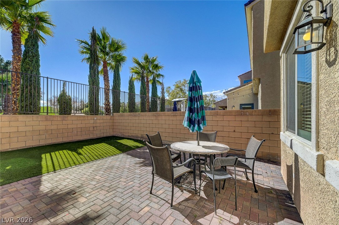 113 Elm Reed Avenue Las Vegas, NV 89113 - Photo 52 of 62 Fenced backyard featuring a patio area and outdoor dining space