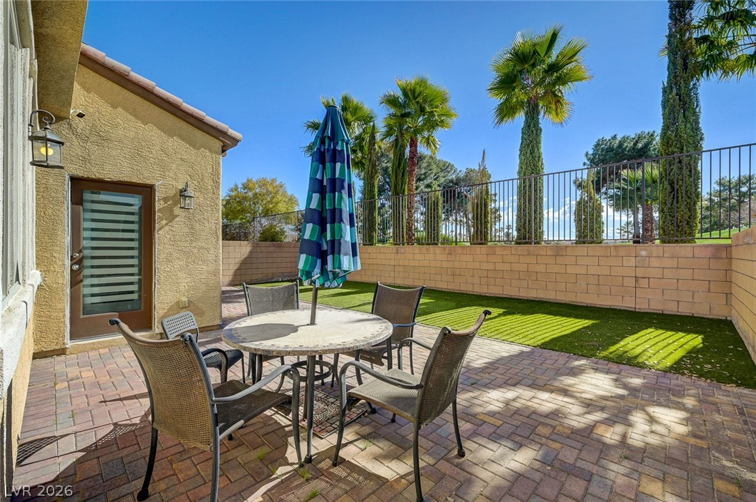 113 Elm Reed Avenue Las Vegas, NV 89113 - Photo 53 of 62 Fenced backyard with a patio and outdoor dining area