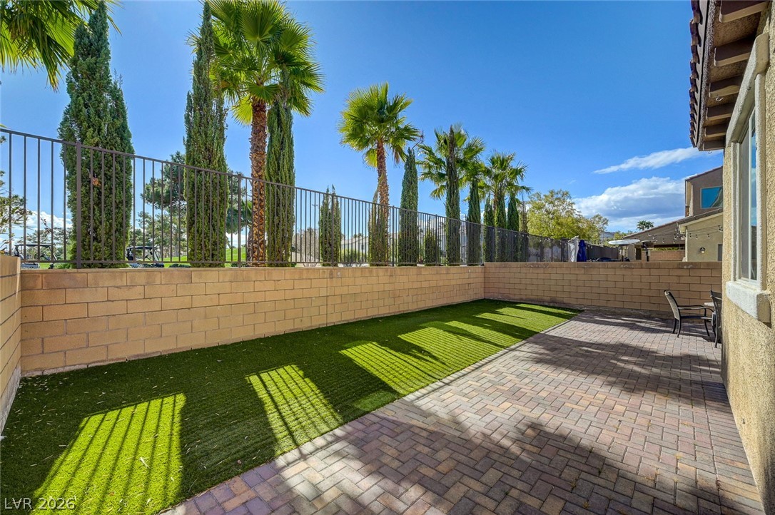 113 Elm Reed Avenue Las Vegas, NV 89113 - Photo 55 of 62 Fenced backyard with a patio