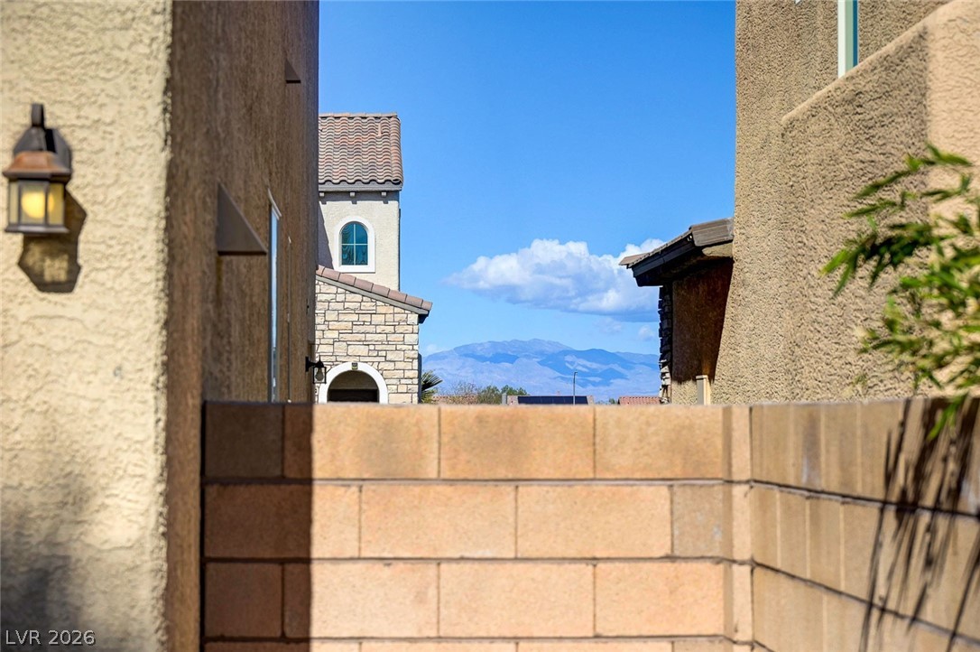 113 Elm Reed Avenue Las Vegas, NV 89113 - Photo 56 of 62 Exterior view of a mountainous background, stone siding, and stucco siding