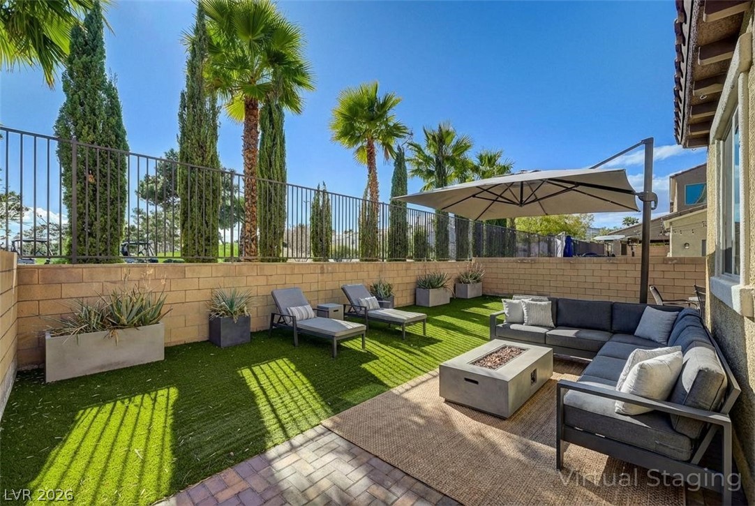113 Elm Reed Avenue Las Vegas, NV 89113 - Photo 8 of 62 Fenced backyard with an outdoor living space with a fire pit and a patio