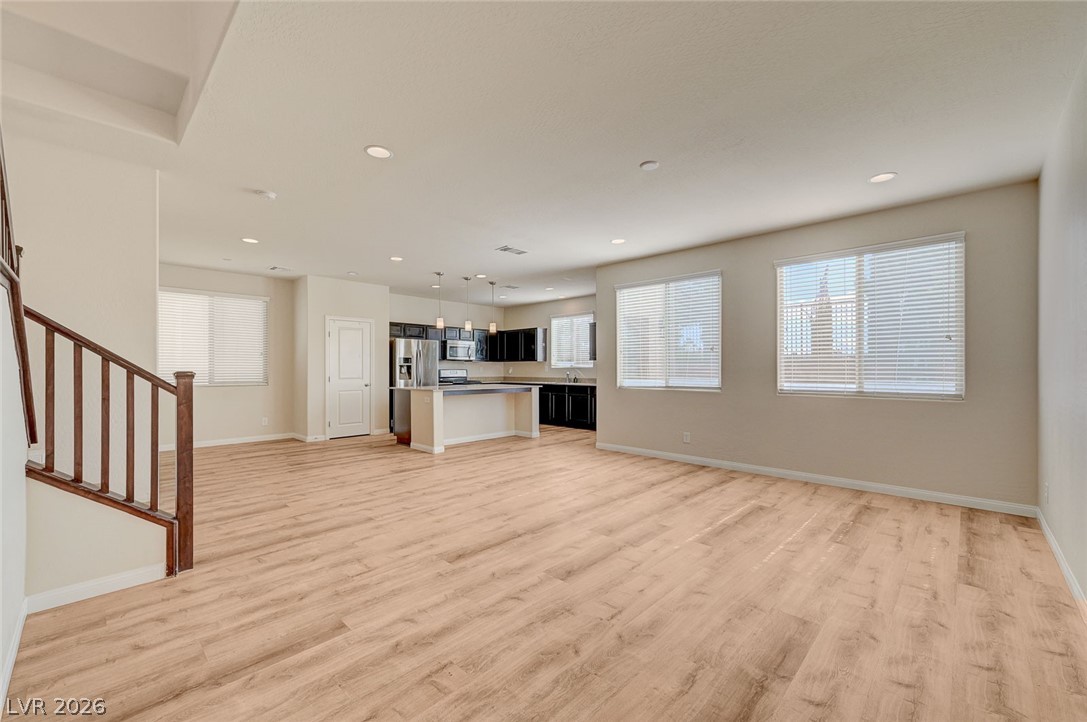 113 Elm Reed Avenue Las Vegas, NV 89113 - Photo 9 of 62 Unfurnished living room featuring light wood-style floors and recessed lighting