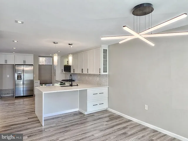 a view of a room with wooden floor and a window