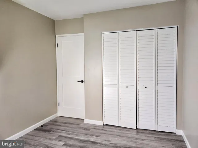 a view of entryway with wooden floor and stairs