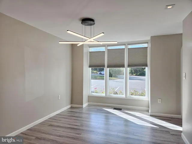 a large kitchen with a large window and stainless steel appliances