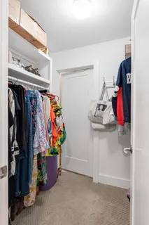 a view of walk in closet with clothes