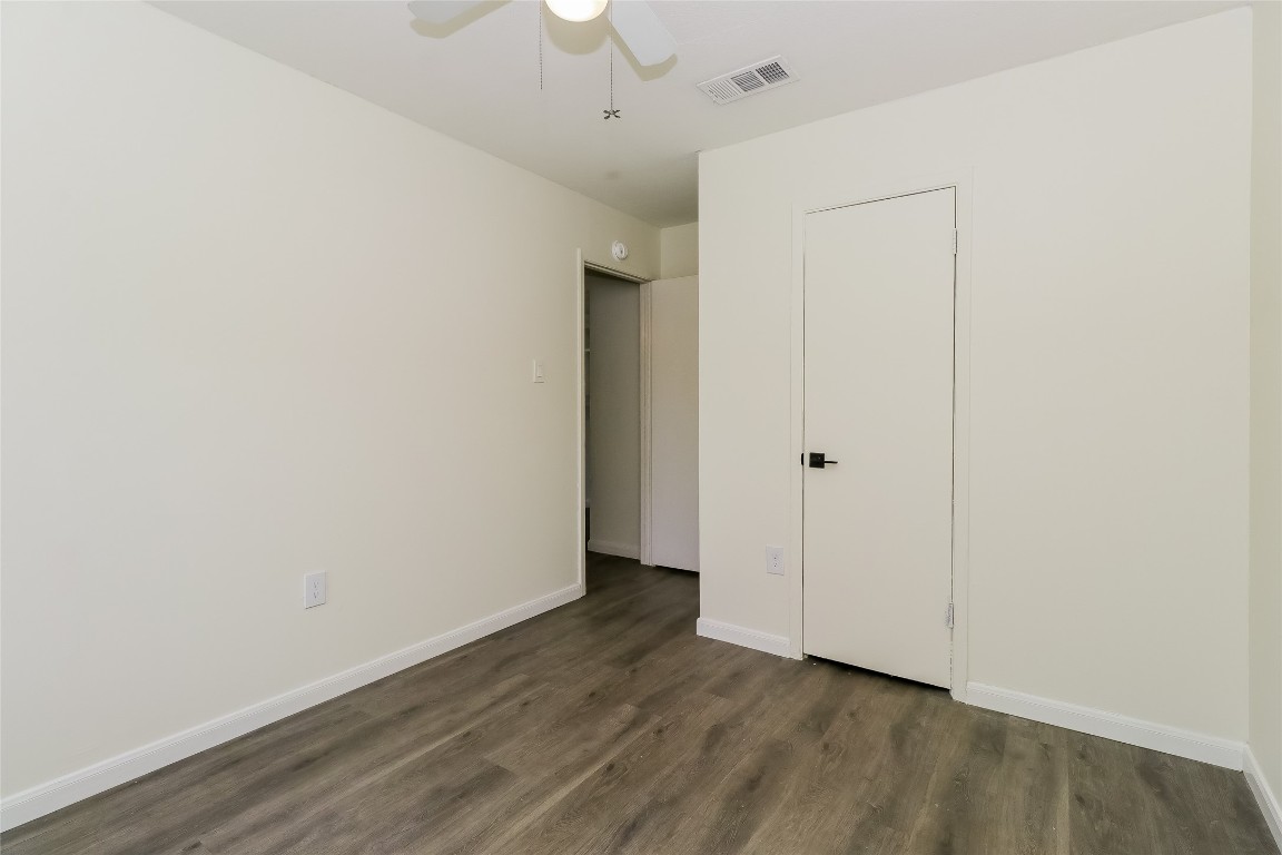 2803 Cornish Circle Austin, TX 78745 - Photo 11 of 16 Unfurnished bedroom featuring dark wood-style floors and a ceiling fan