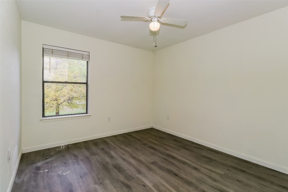2803 Cornish Circle Austin, TX 78745 - Photo 12 of 16 Empty room featuring dark wood-type flooring and ceiling fan