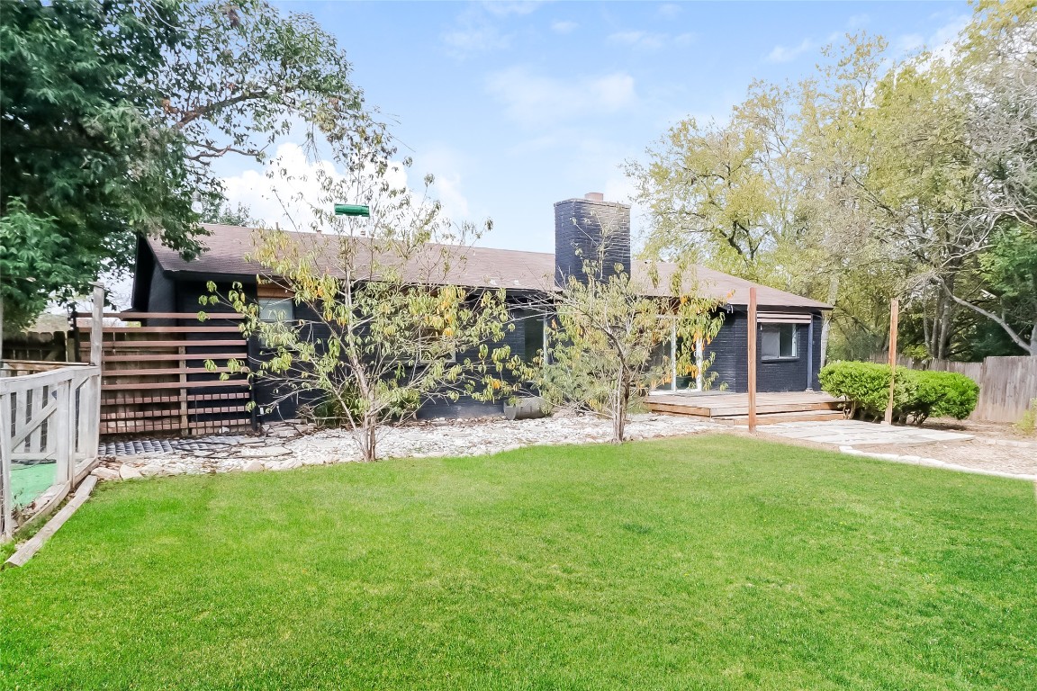 2803 Cornish Circle Austin, TX 78745 - Photo 15 of 16 Rear view of house featuring a chimney and a wooden deck