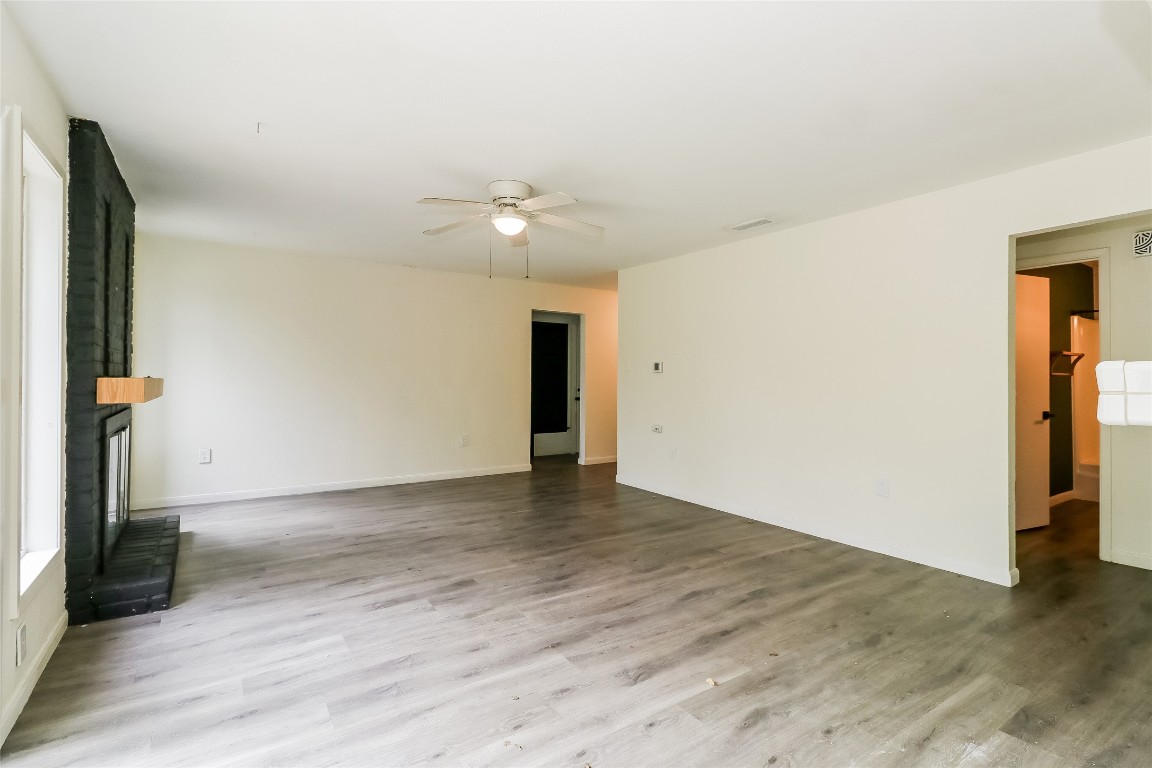 2803 Cornish Circle Austin, TX 78745 - Photo 3 of 16 Unfurnished living room with a ceiling fan and light wood-type flooring