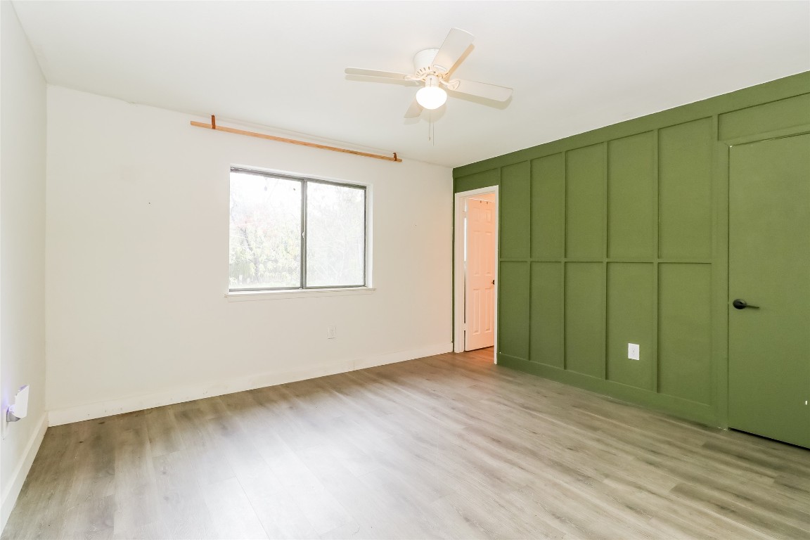 2803 Cornish Circle Austin, TX 78745 - Photo 9 of 16 Unfurnished bedroom featuring a ceiling fan, a closet, and light wood finished floors
