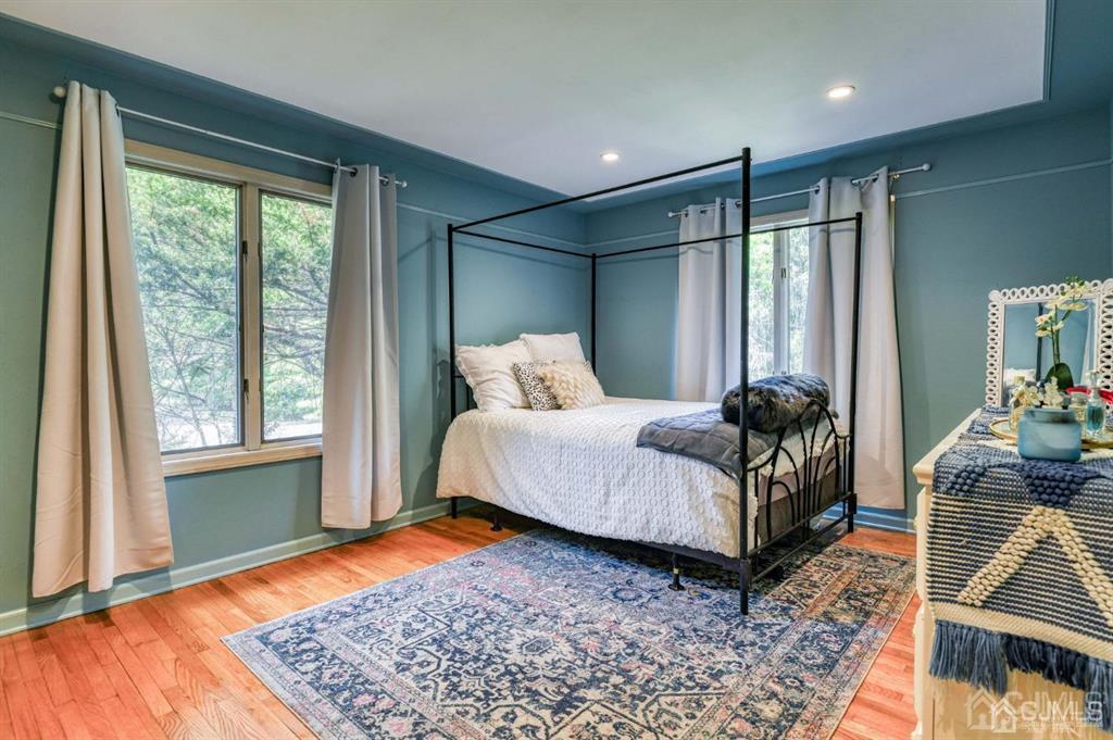 59 Friendship Road Cranbury, NJ 08512 - Photo 25 of 31 a bedroom with a bed lamps and wooden floor