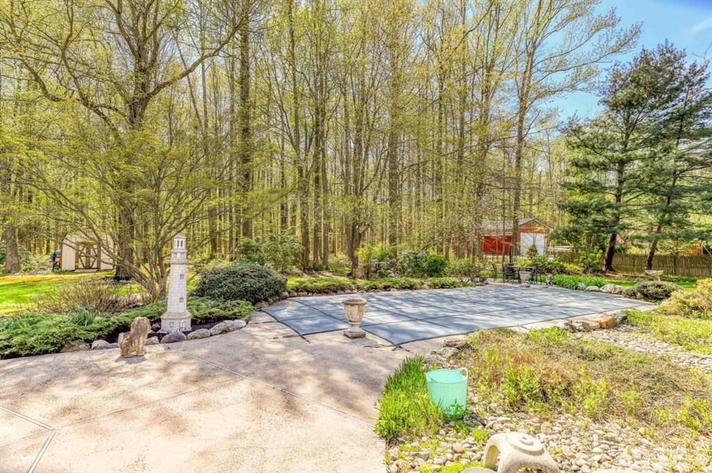 59 Friendship Road Cranbury, NJ 08512 - Photo 7 of 31 a view of a backyard with plants and trees