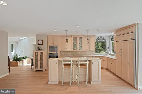 a kitchen with a sink window and cabinets