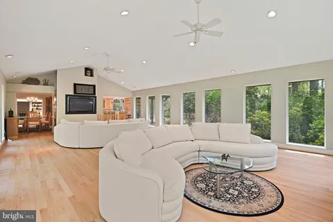 a living room with furniture a fireplace and a large window