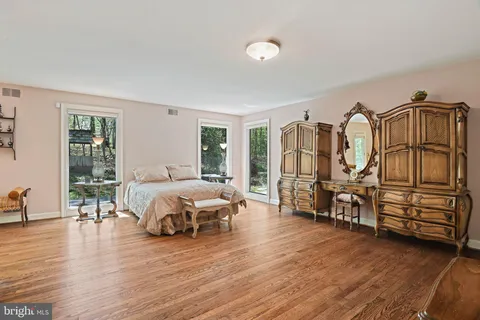a spacious bedroom with a bed and a large window