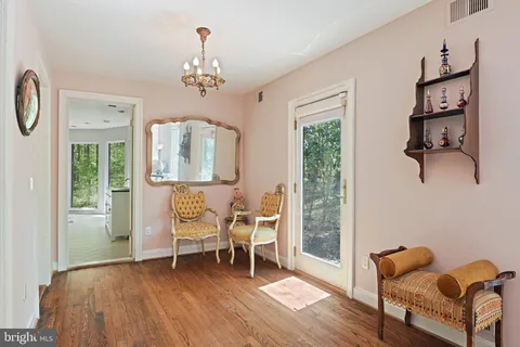 a white bath tub sitting in a room next to a window