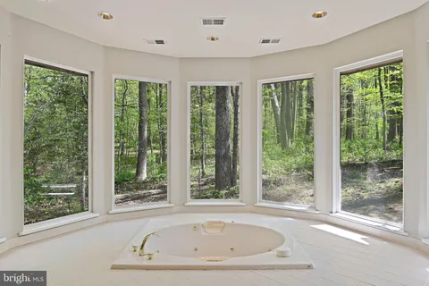 a spacious bathroom with a large tub and sink
