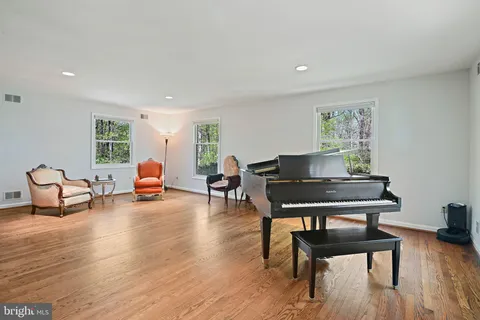 a living room with furniture and wooden floors