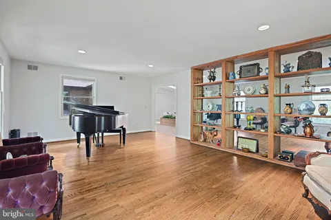 a kitchen with a sink and wooden floor
