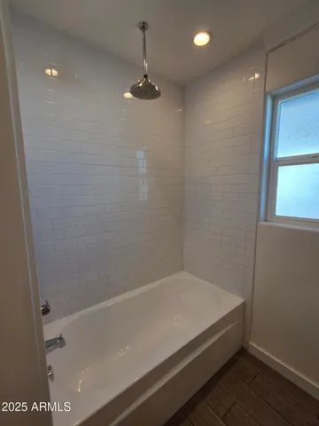 a bathroom with a granite countertop sink a toilet and a mirror