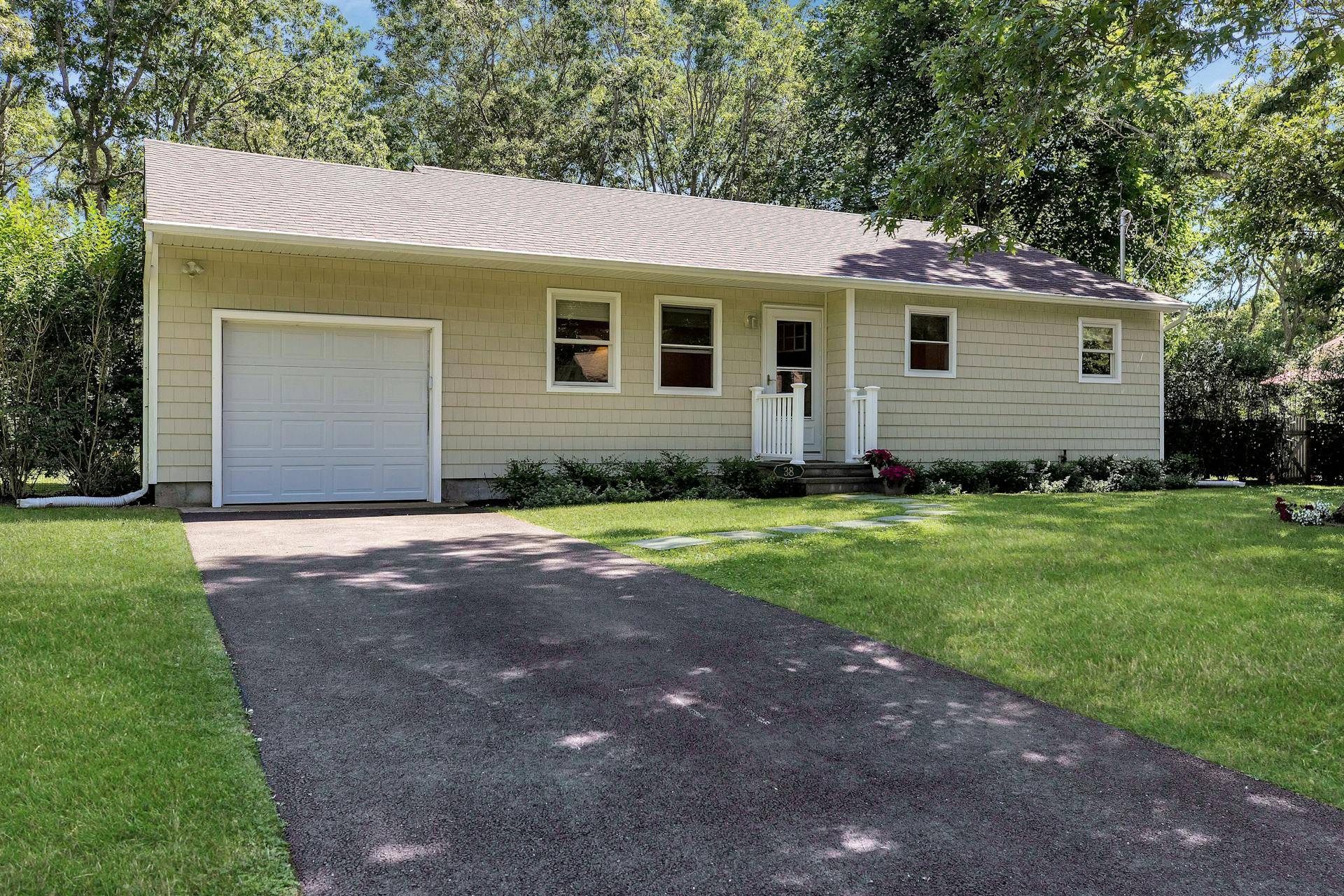 38 Woodridge Road Hampton Bays, NY 11946 - Photo 1 of 31 a view of a house with a yard