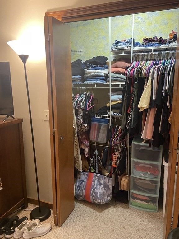 132 West Meadow Road, Unit 7 Haverhill, MA 01832 - Photo 12 of 12 a view of walk in closet with clothes and shoes