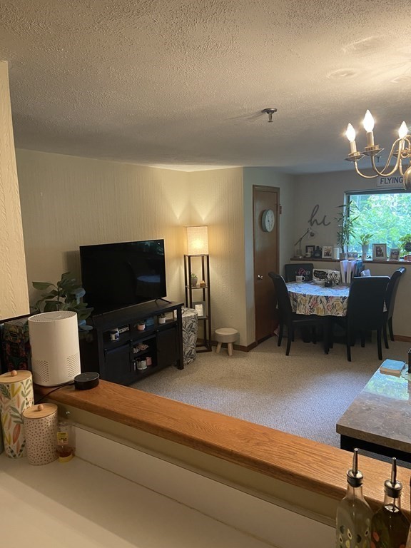 132 West Meadow Road, Unit 7 Haverhill, MA 01832 - Photo 4 of 12 a living room with furniture and a flat screen tv