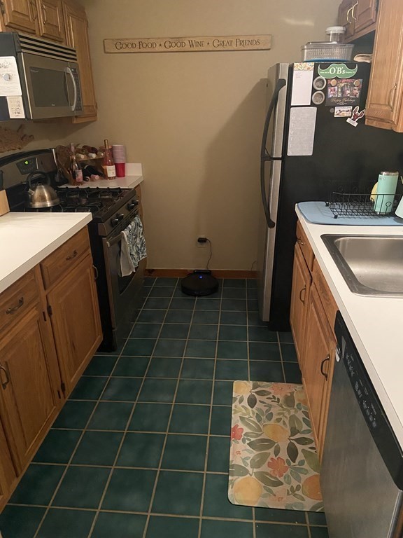 132 West Meadow Road, Unit 7 Haverhill, MA 01832 - Photo 5 of 12 a kitchen with a sink a stove top oven and cabinets