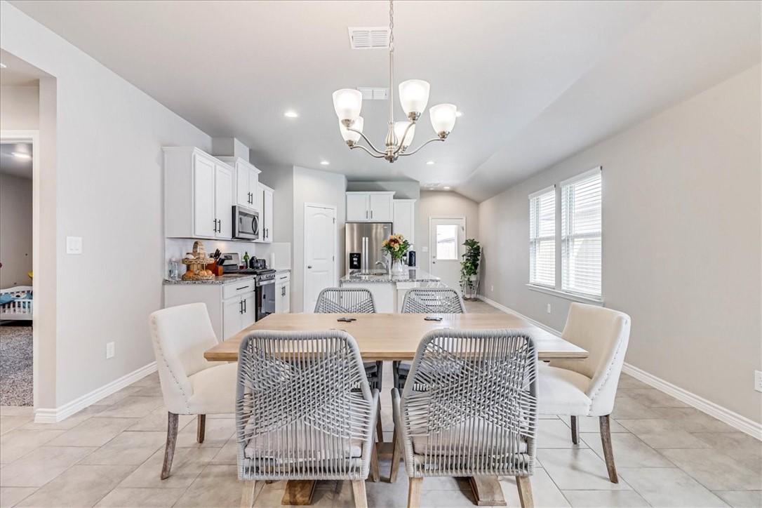 7630 Shadow Rider Lane Corpus Christi, TX 78414 - Photo 14 of 39 a view of a dining room with furniture and a chandelier