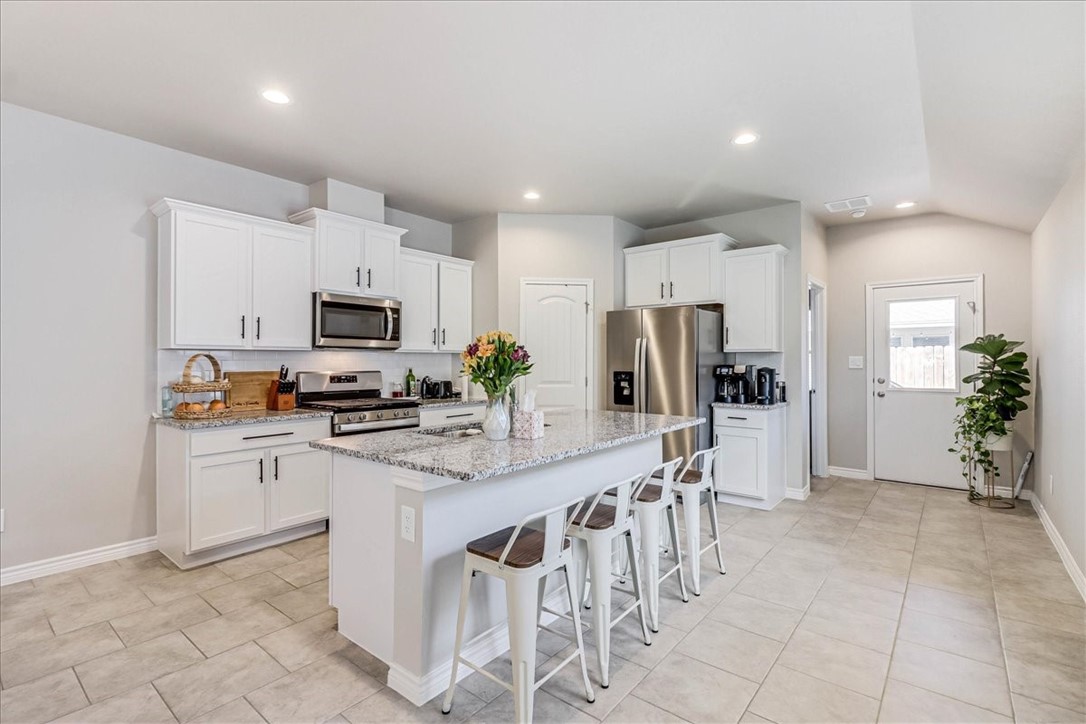 7630 Shadow Rider Lane Corpus Christi, TX 78414 - Photo 2 of 39 a kitchen with stainless steel appliances granite countertop a refrigerator and a stove top oven