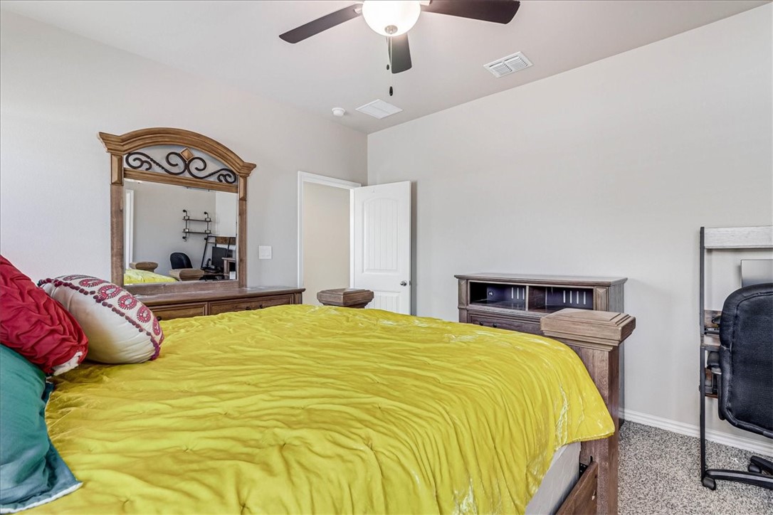 7630 Shadow Rider Lane Corpus Christi, TX 78414 - Photo 22 of 39 a bedroom with a bed and a chandelier