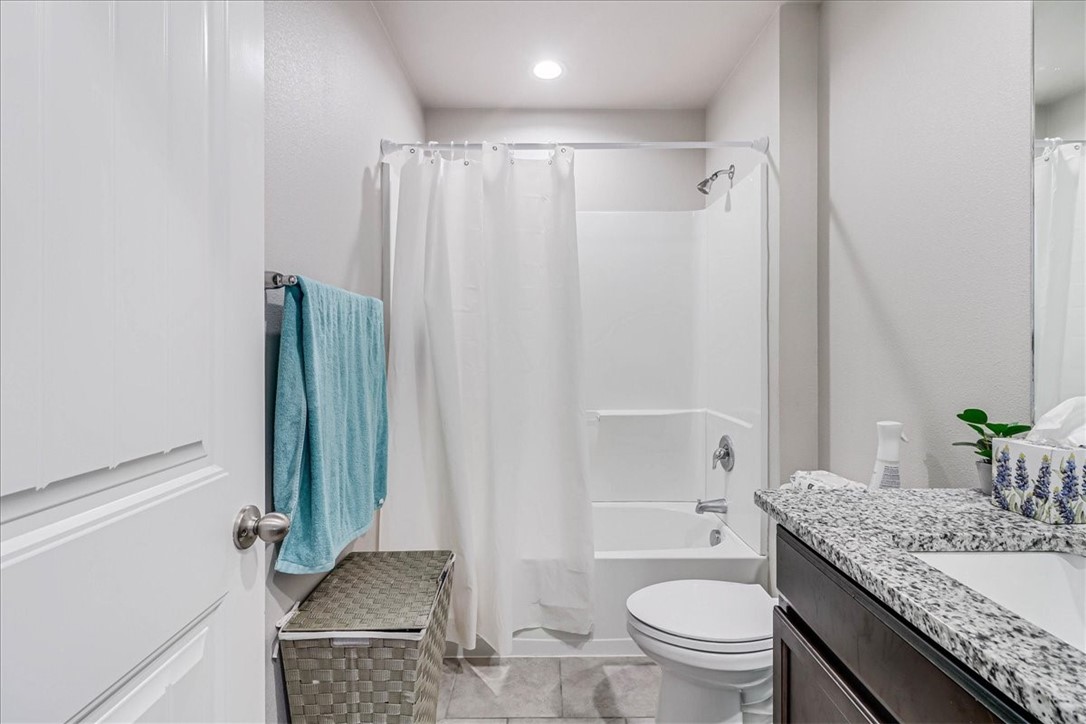 7630 Shadow Rider Lane Corpus Christi, TX 78414 - Photo 30 of 39 a bathroom with a granite countertop sink toilet and shower