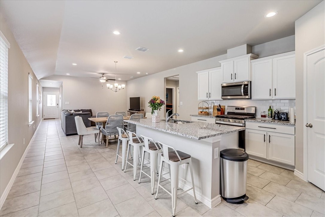 7630 Shadow Rider Lane Corpus Christi, TX 78414 - Photo 3 of 39 a kitchen with appliances a sink a counter top space and cabinets