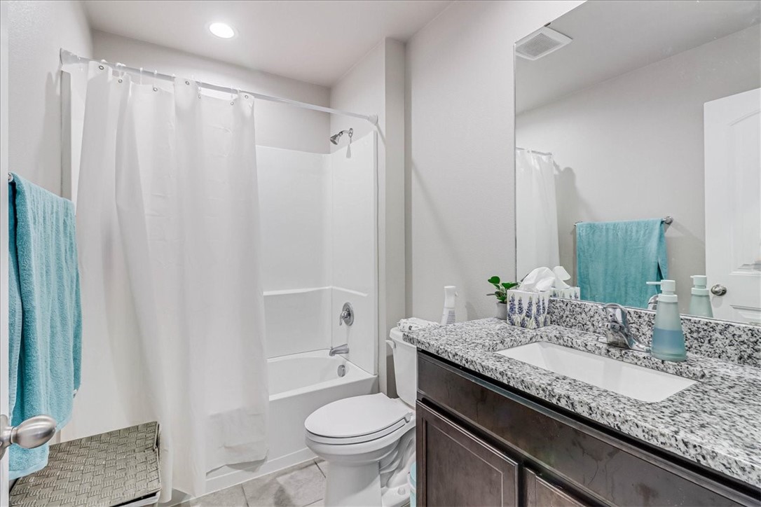 7630 Shadow Rider Lane Corpus Christi, TX 78414 - Photo 31 of 39 a bathroom with a granite countertop sink and a mirror